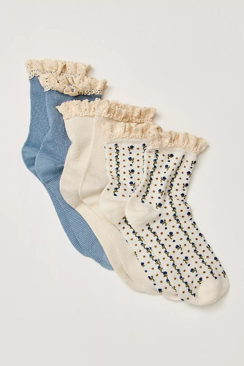 Trestles Clothing Company ruffle sock pack featuring blue, cream, and floral waffle knit crew socks with lace trim.